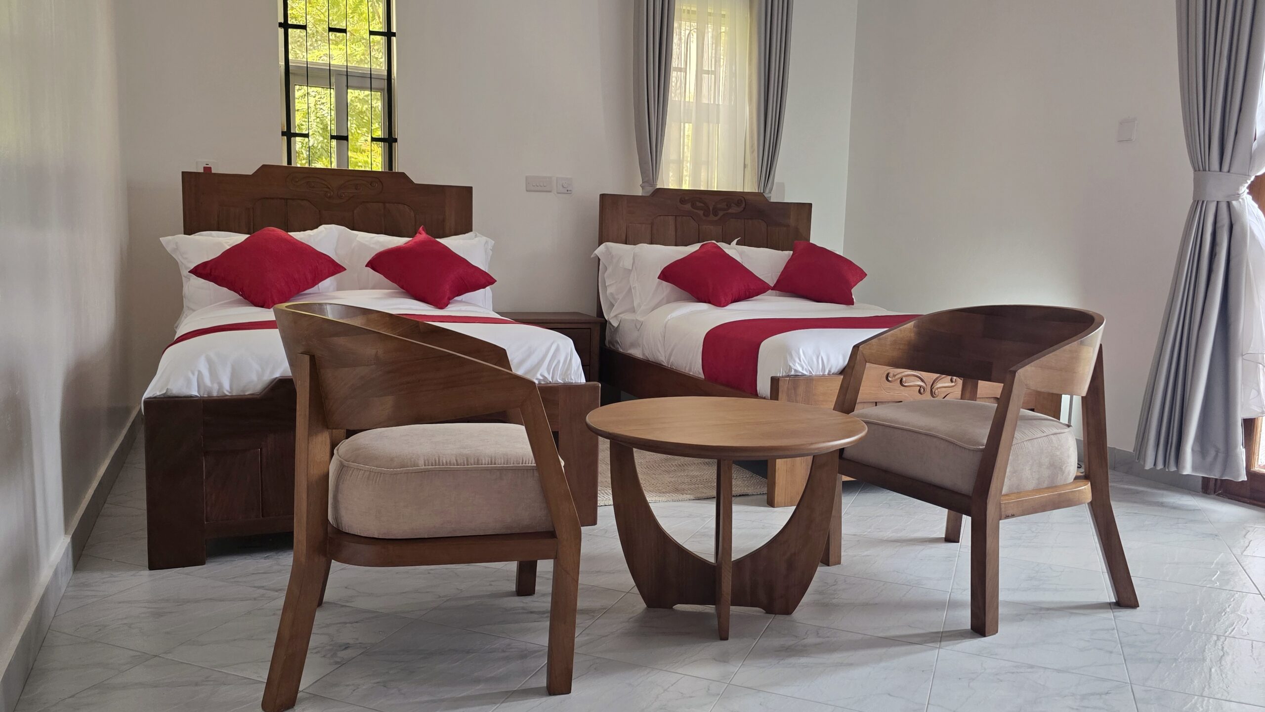 Spacious guest bedroom at Salt Sun Retreat Villa in Diani Beach with two twin beds and tropical décor