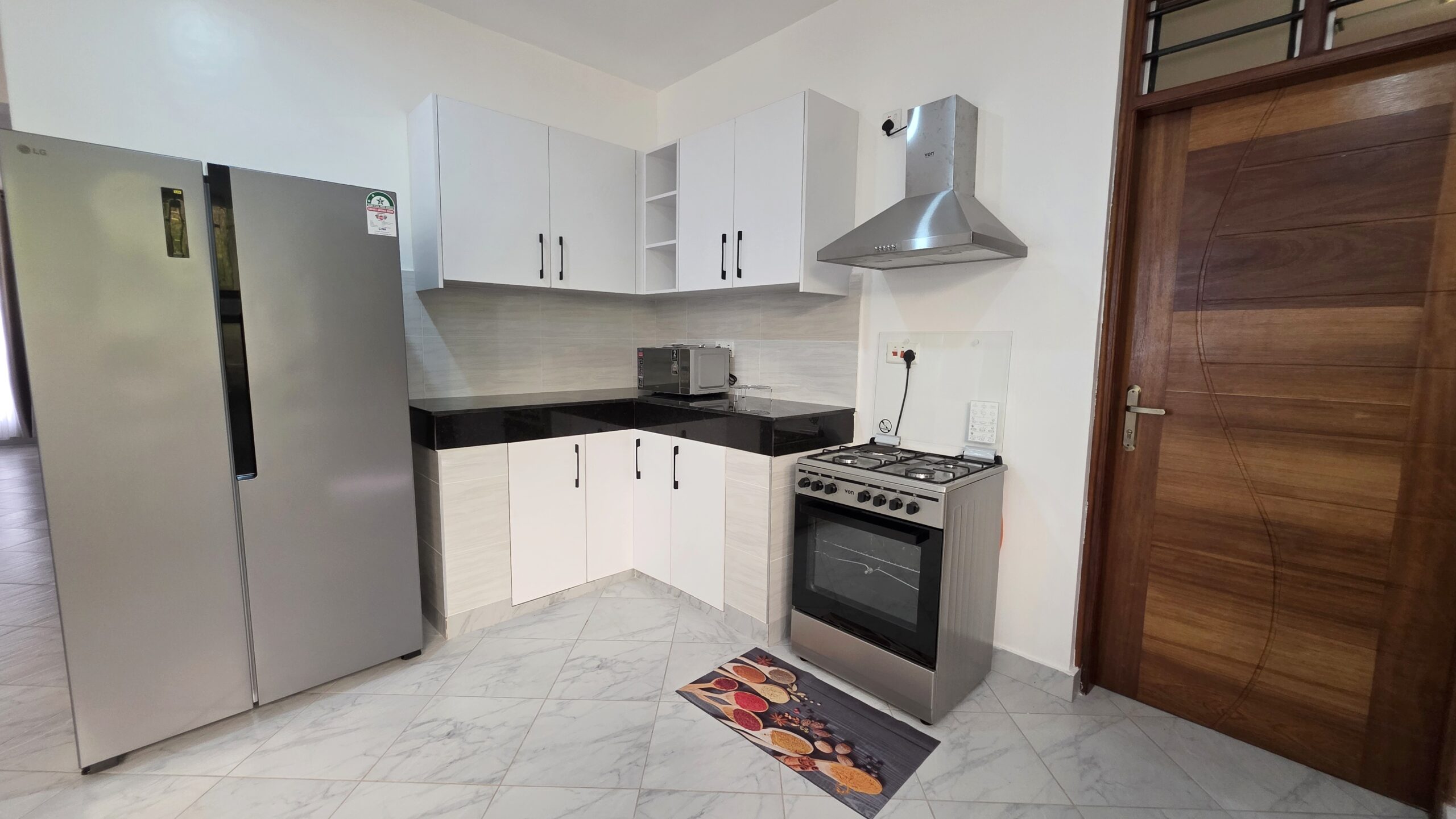 Modern kitchen at Salt Sun Retreat Villa in Diani Beach with sleek countertops, ample storage, and cooking amenities