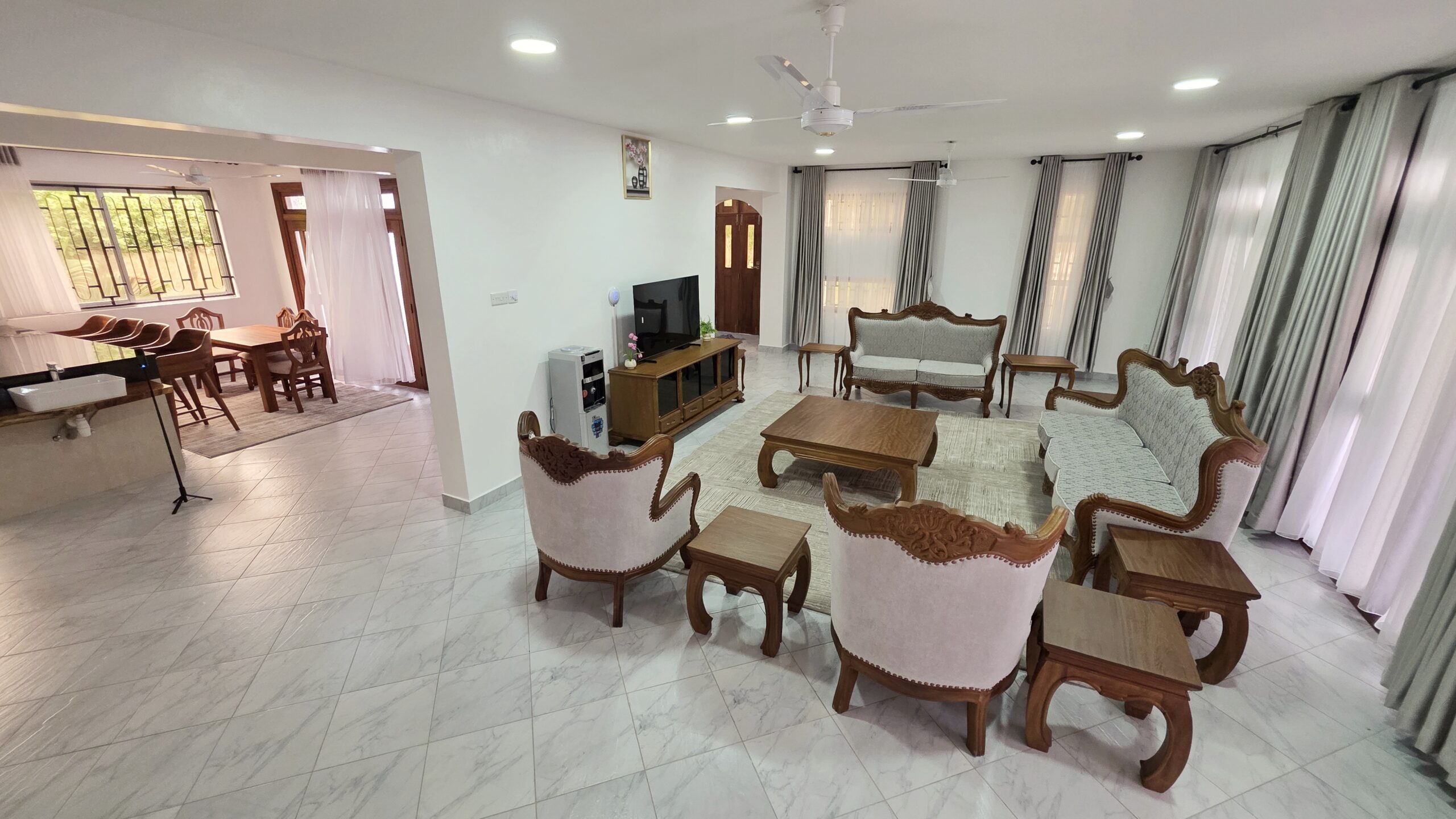 Open-plan living area at Salt Sun Retreat Villa in Diani Beach with comfortable seating, dining space, and modern kitchen